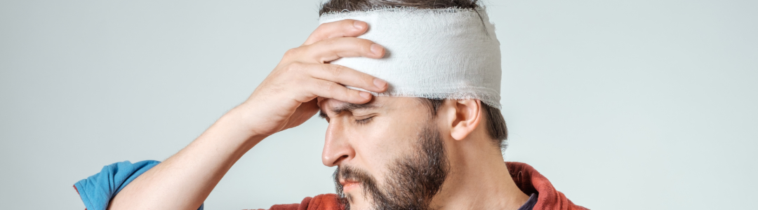 man with a bandage for his head injury