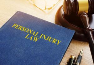 Personal injury law book and gavel on a desk